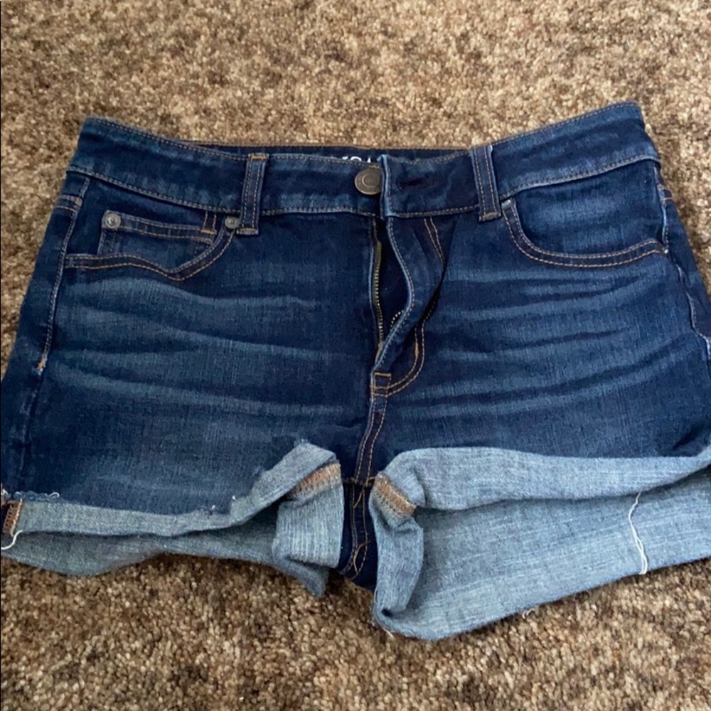 Dark wash American Eagle shorts.